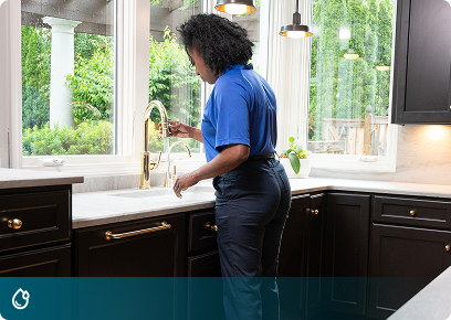 Plumbing CTA Plumbing services: Academy Air technician checking a kitchen sink faucet